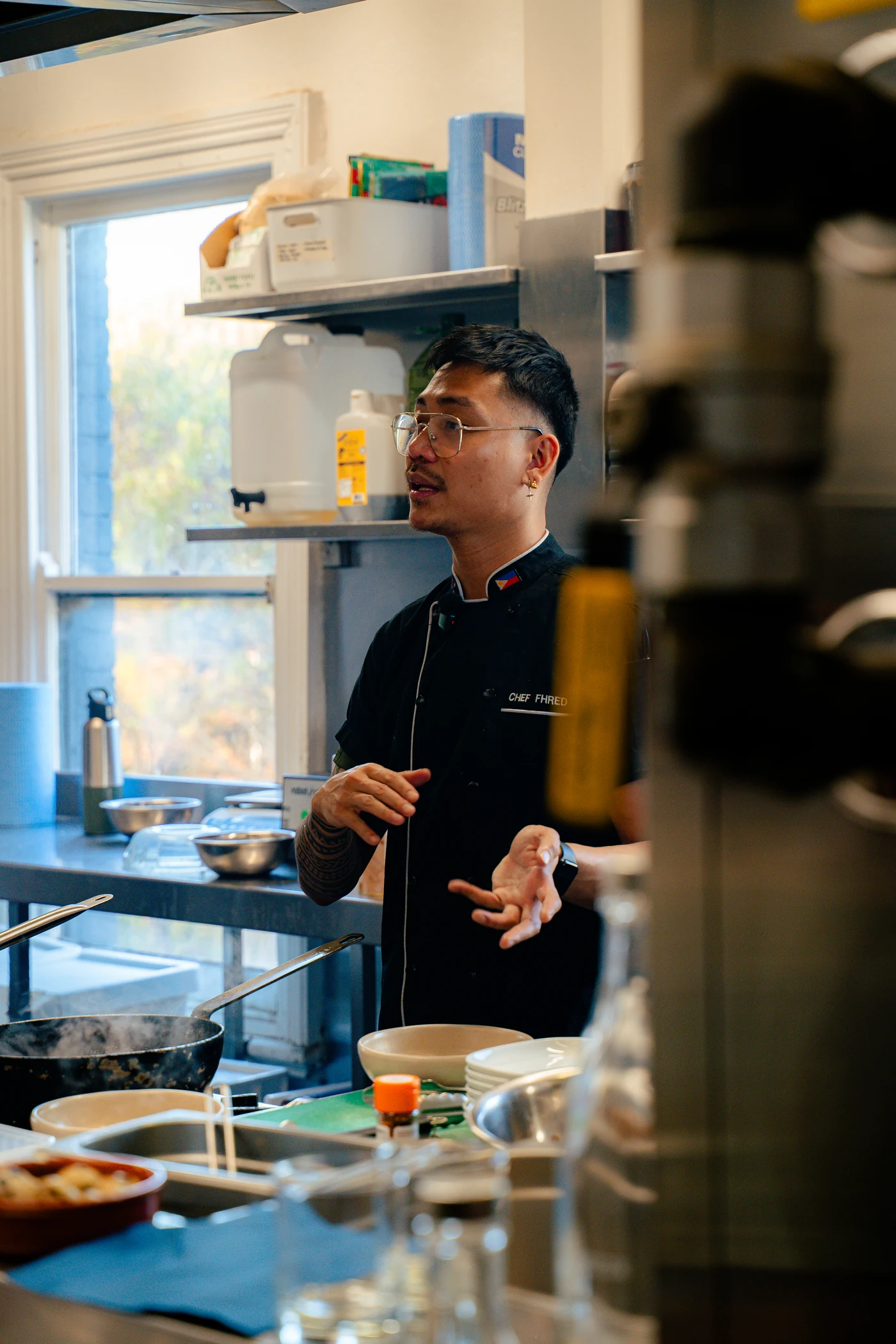Chef Fhred working in a professional kitchen in his chef jacket